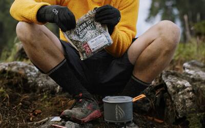a person feasting on a sustainably packaged farm to summit meal in the backcountry